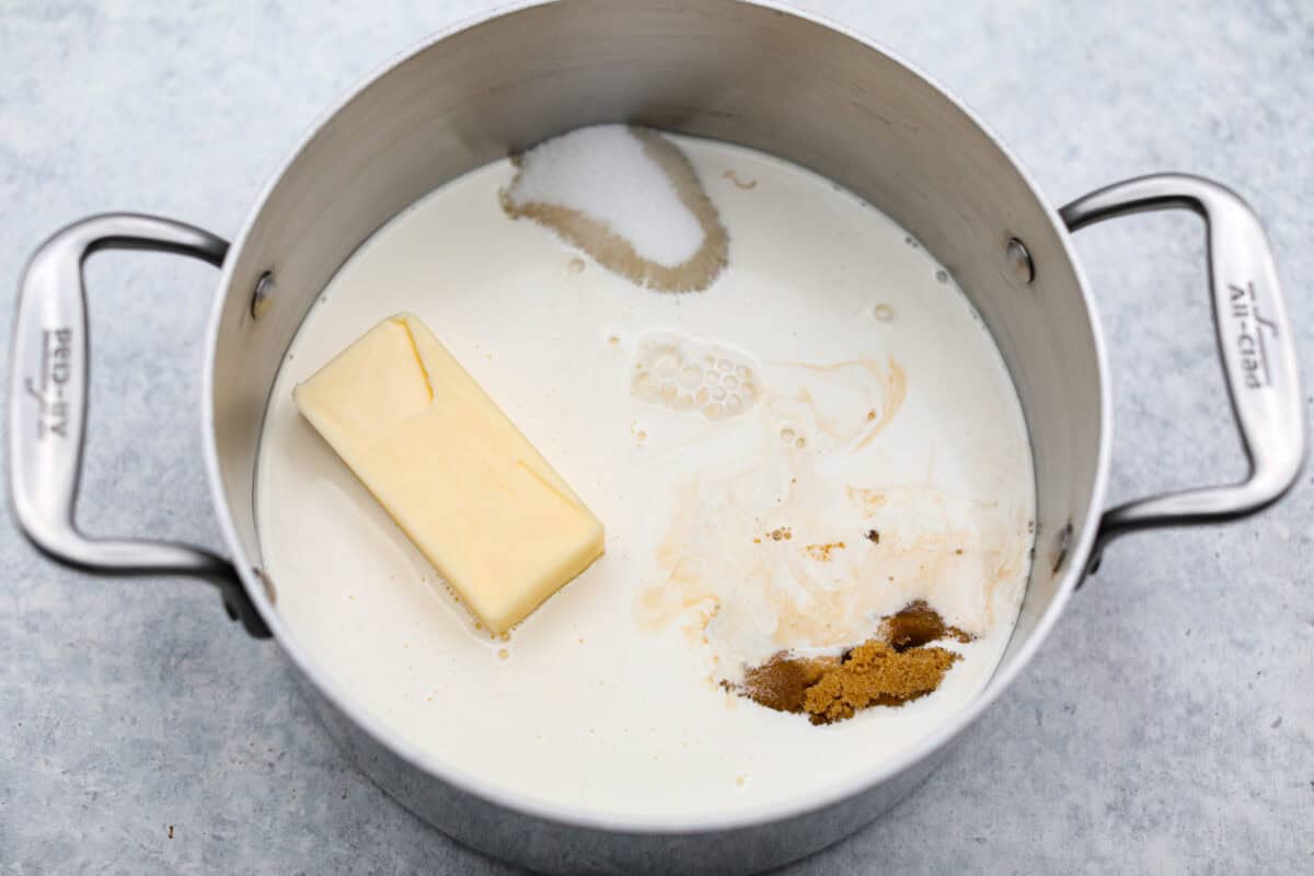Homemade Caramels are perfectly buttery soft with just the right amount of sweet. They are easy to make and are the perfect neighbor gift for the holiday season. Overhead shot of butter, cream, sugars, corn syrup, evaporated milk and salt in a heavy-bottom saucepan.