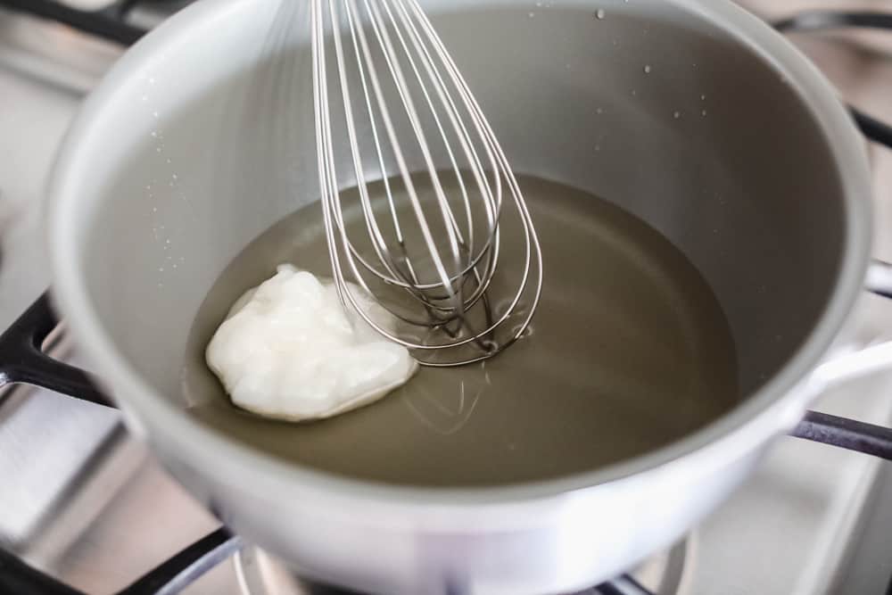 Maple Plant Butter (Three Ways!) is a smooth, creamy plant based butter that spreads perfectly over a piece of fresh bread and melts into all the cracks! You won't be able to live without it! Whisking ingredients in a bowl