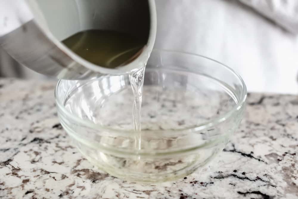 Maple Plant Butter (Three Ways!) is a smooth, creamy plant based butter that spreads perfectly over a piece of fresh bread and melts into all the cracks! You won't be able to live without it! Pouring oils into bowl