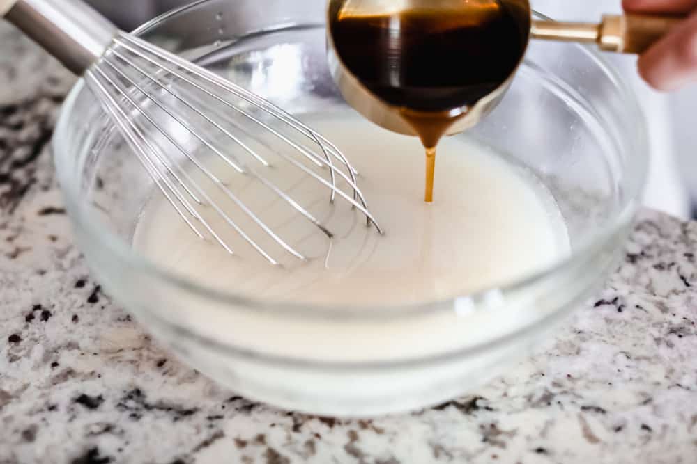 Maple Plant Butter (Three Ways!) is a smooth, creamy plant based butter that spreads perfectly over a piece of fresh bread and melts into all the cracks! You won't be able to live without it! Adding ingredients to the bowl and whisking