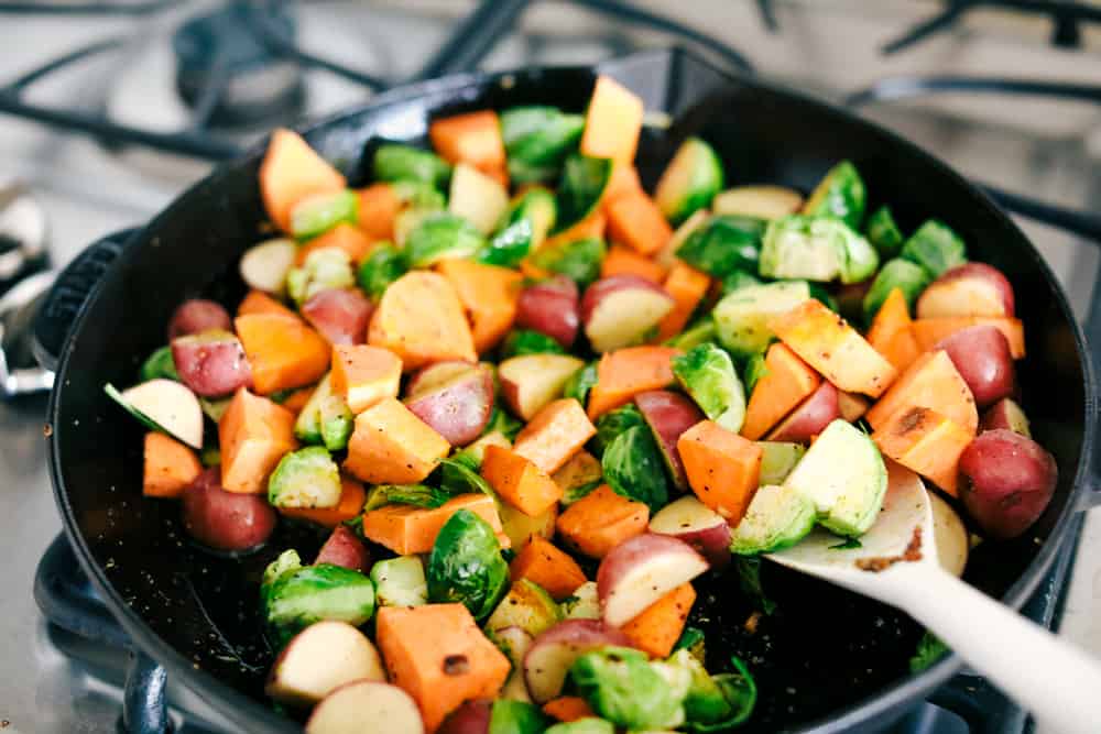 Skillet Pork Chops with Maple Dijon Vegetables is marinated Smithfield Steakhouse Mushroom Flavored Pork cut into pieces andย sautรฉed with tender vegetables covered with aย golden mapleย glaze. All under 30 minutes! vegetables in a skillet on the stove top