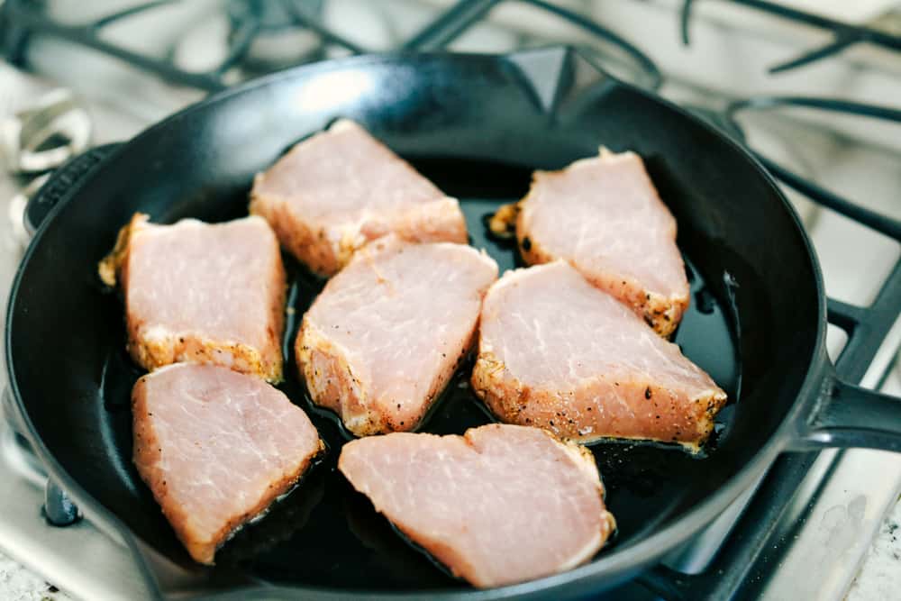 Skillet Pork Chops with Maple Dijon Vegetables is marinated Smithfield Steakhouse Mushroom Flavored Pork cut into pieces andย sautรฉed with tender vegetables covered with aย golden mapleย glaze. All under 30 minutes! pork chops in a skillet cooking