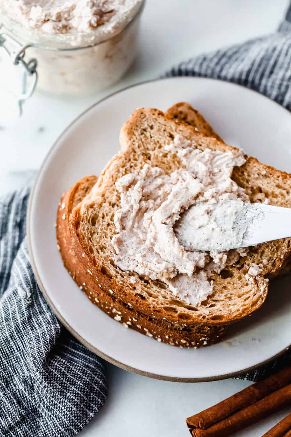 Maple Plant Butter (Three Ways!) is a smooth, creamy plant based butter that spreads perfectly over a piece of fresh bread and melts into all the cracks! You won't be able to live without it! Maple Plant Butter spread on toast