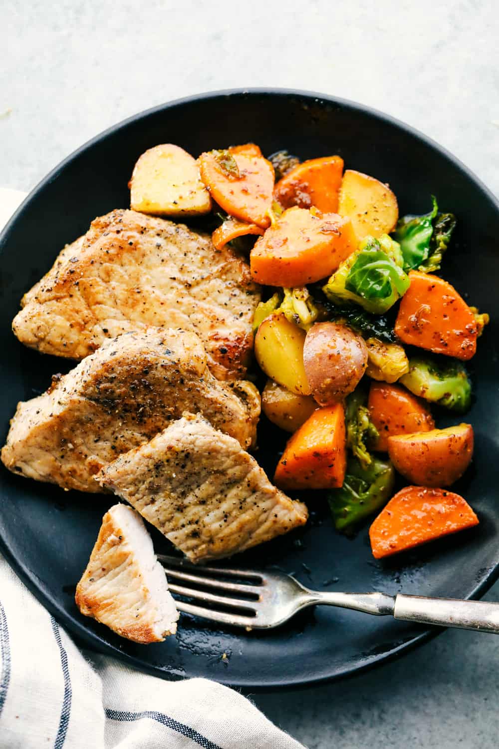Skillet Pork Chops with Maple Dijon Vegetables is marinated Smithfield Steakhouse Mushroom Flavored Pork cut into pieces andย sautรฉed with tender vegetables covered with aย golden mapleย glaze. All under 30 minutes! skillet pork chops with maple dijon vegetables on a plate