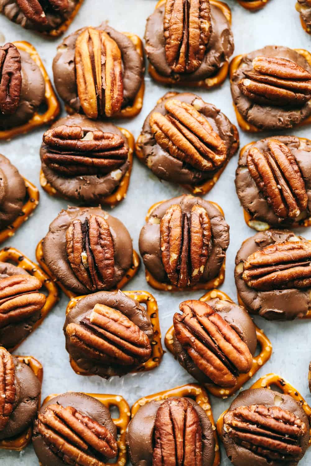 This Rolo Pretzel Turtle Recipe has a hard, salty pretzel layered with a caramel hidden inside a chocolate for a creamy inside topped with a crisp pecan. This salty and sweet treat is perfect for the holidays this season! rolo pretzel turtles