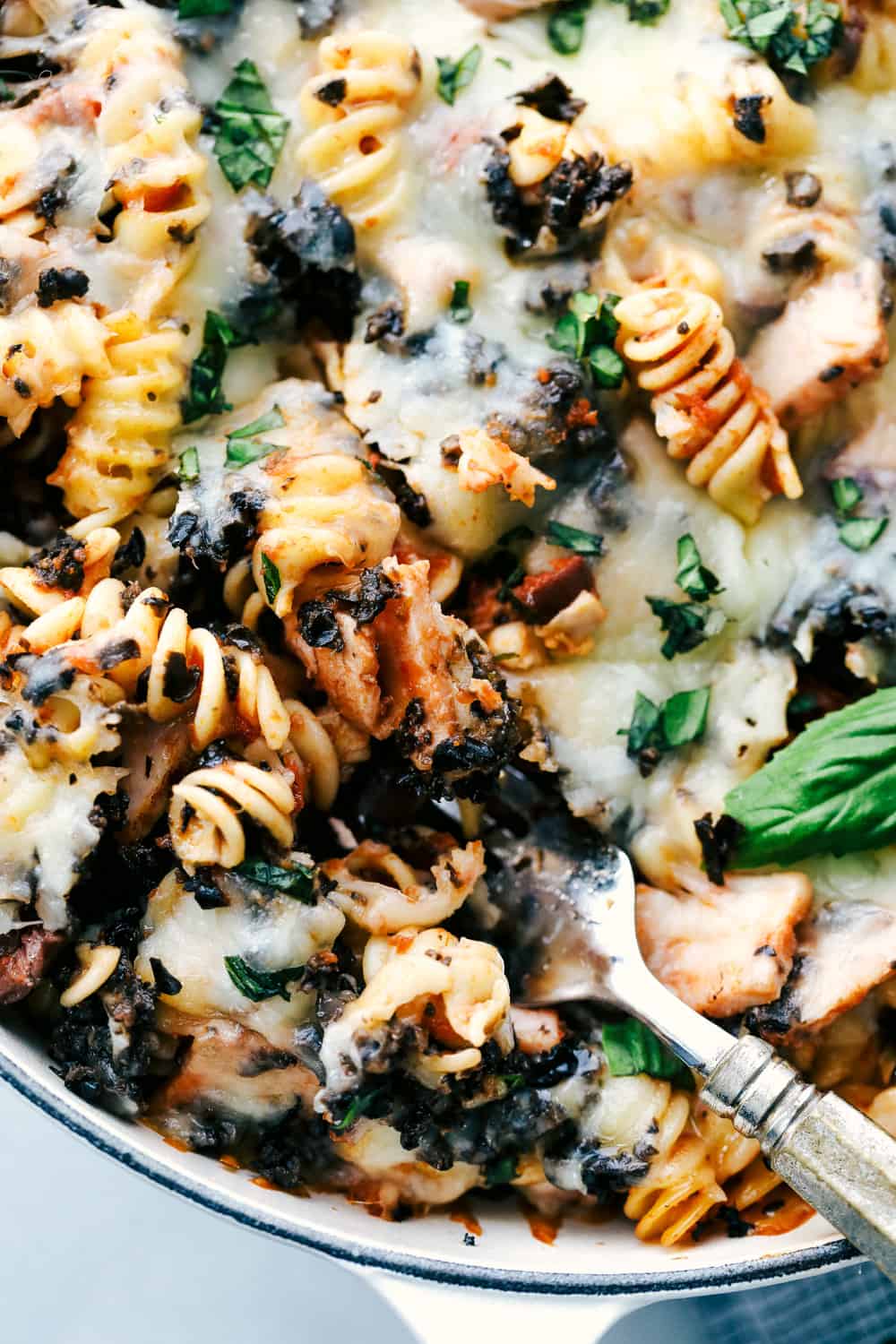 This Turkey Mediterranean Casserole features artichokes, fusilli pasta, sun dried tomatoes and Lindsay® Kalamata Olives baked in a red tomato sauce and topped with Lindsay® Chopped Black Olives. Simple, delicious ingredients in 30 minutes! Up close photo of the Turkey Mediterranean casserole.