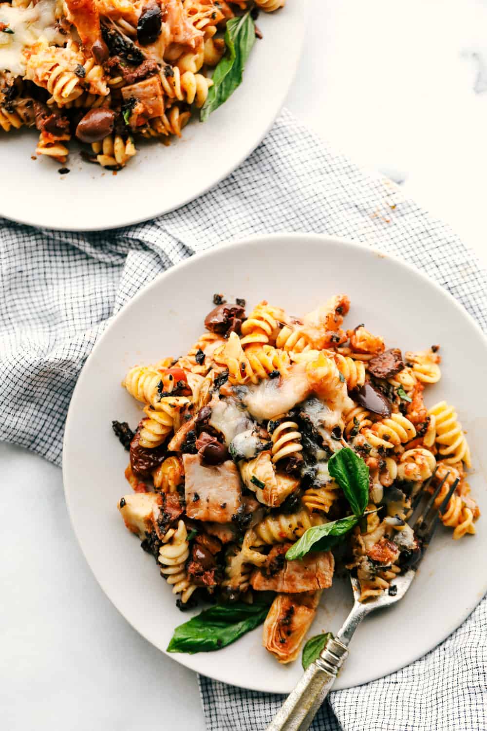 This Turkey Mediterranean Casserole features artichokes, fusilli pasta, sun dried tomatoes and Lindsay® Kalamata Olives baked in a red tomato sauce and topped with Lindsay® Chopped Black Olives. Simple, delicious ingredients in 30 minutes! Turkey Mediterranean Casserole on a plate