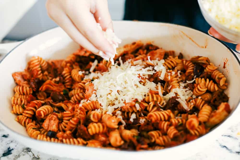 This Turkey Mediterranean Casserole features artichokes, fusilli pasta, sun dried tomatoes and Lindsay® Kalamata Olives baked in a red tomato sauce and topped with Lindsay® Chopped Black Olives. Simple, delicious ingredients in 30 minutes! turkey mediterranean casserole in a dish.