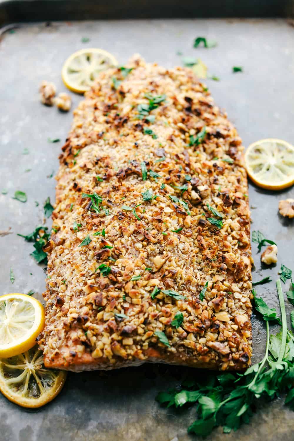 Walnut Crusted Maple Salmon is a savory salmon dish that is coated in a sweet maple syrup, delicious Dijon mustard coated with a thick walnut crust all baked to perfection. Baked in under 30 minutes! Walnut crusted maple salmon baked