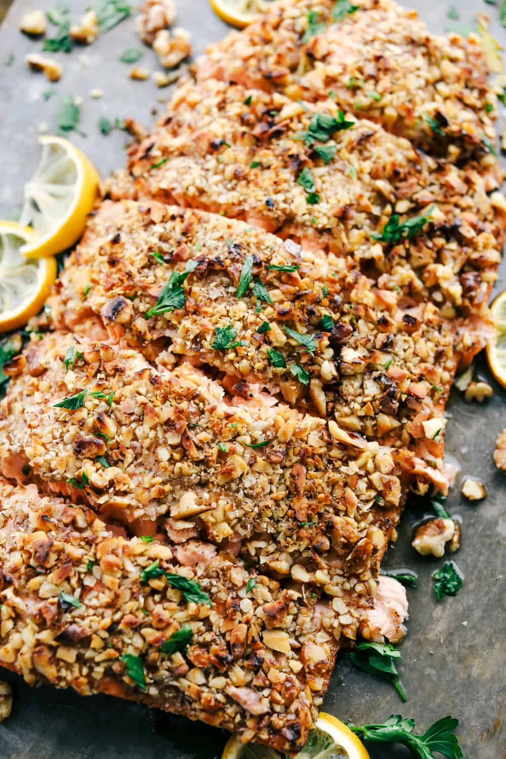 Walnut Crusted Maple Salmon is a savory salmon dish that is coated in a sweet maple syrup, delicious Dijon mustard coated with a thick walnut crust all baked to perfection. Baked in under 30 minutes! Walnut crusted maple salmon cut into sections
