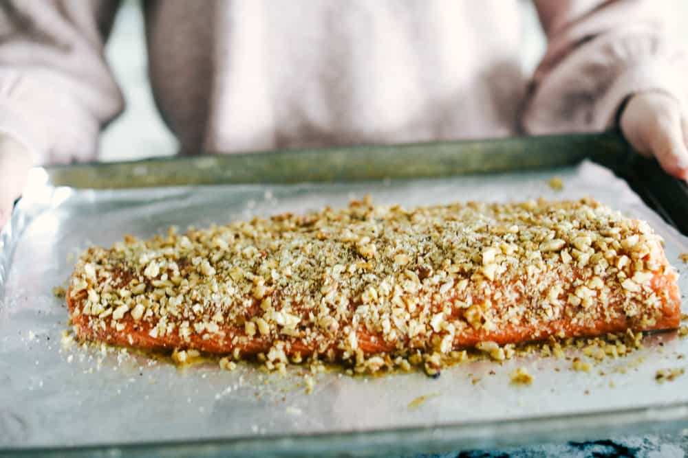 Walnut Crusted Maple Salmon is a savory salmon dish that is coated in a sweet maple syrup, delicious Dijon mustard coated with a thick walnut crust all baked to perfection. Baked in under 30 minutes! Walnut crusted maple salmon on a sheet pan and ready to bake.