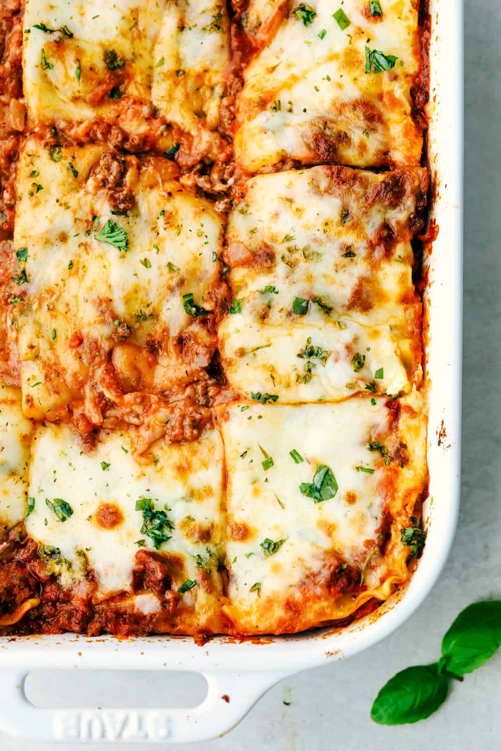 The Best Classic Lasagna Ever has layers of sautéed ground beef and Italian sausage that are cooked together, sweet tomato sauce, Italian seasoning all layered with lasagna noodles then covered in ricotta cheese and a parmesan mixture all sprinkled with mozzarella cheese for a mouthwatering baked Italian dinner. Layers of deliciousness! Lasagna baked in a pan