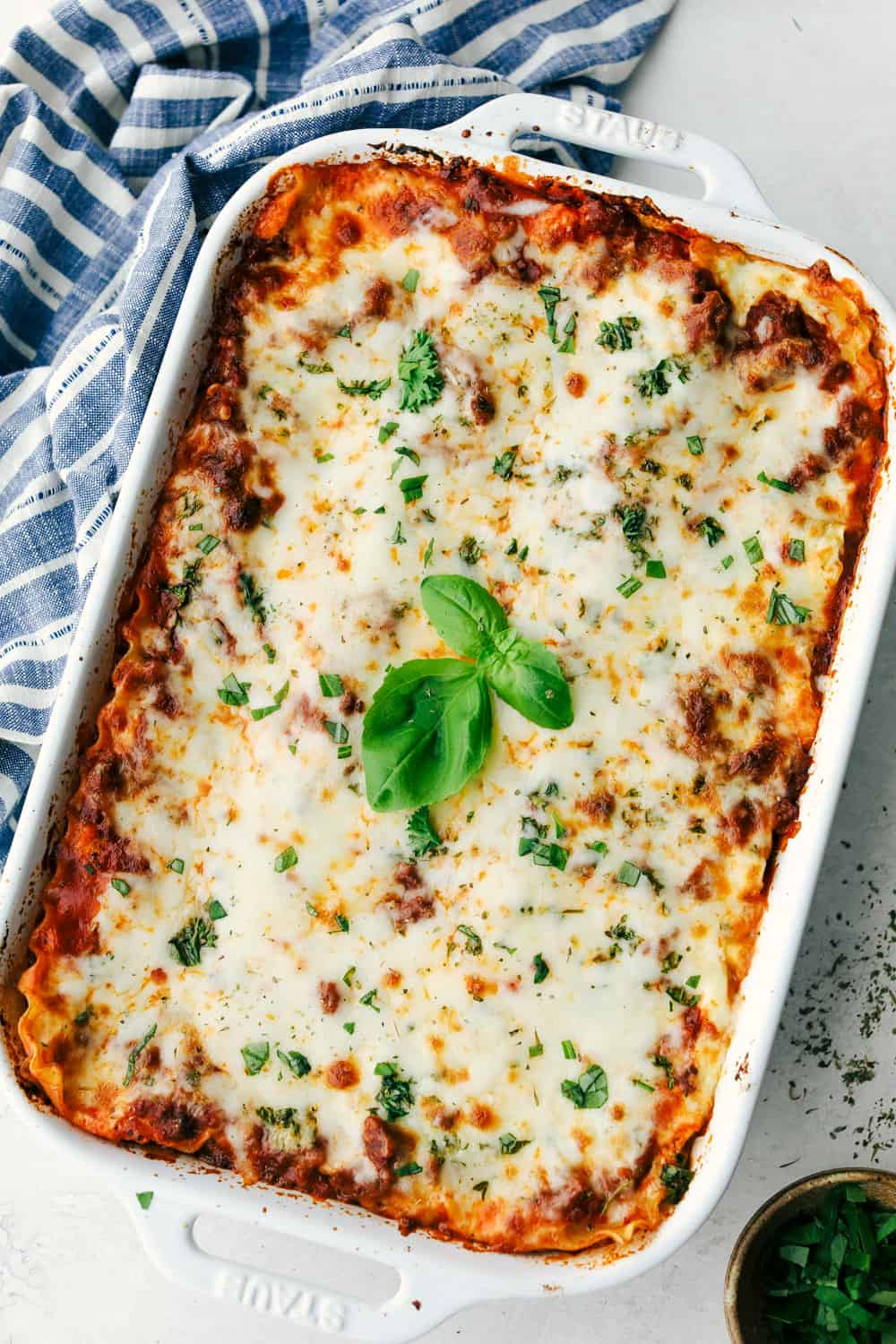 The Best Classic Lasagna Ever has layers of sautéed ground beef and Italian sausage that are cooked together, sweet tomato sauce, Italian seasoning all layered with lasagna noodles then covered in ricotta cheese and a parmesan mixture all sprinkled with mozzarella cheese for a mouthwatering baked Italian dinner. Layers of deliciousness! Baked lasagna