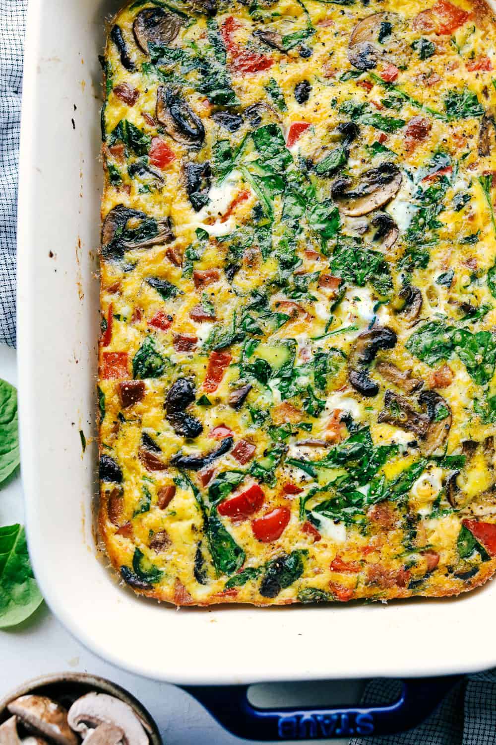 Sausage Mushroom Breakfast Bake is a blend ofย sautรฉed smoked sausage and fresh vegetables, added to a scrambled egg mixture then baked in less that 30 minutes. Thisย breakfast bake is perfect for theย holidays!ย Sausage mushroom breakfast bake baked in a casserole pan.