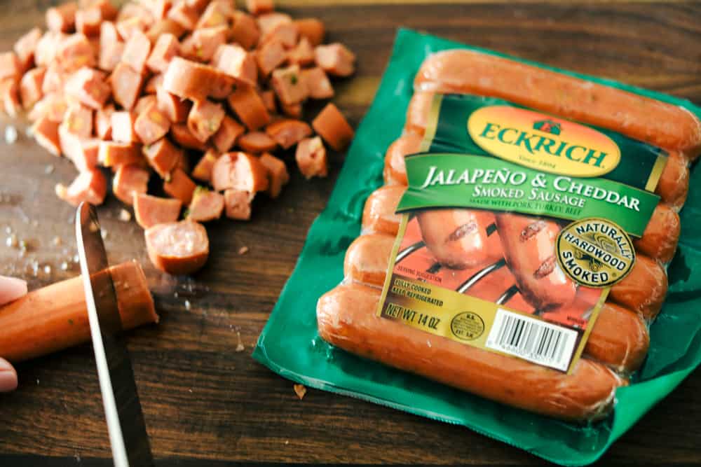 Sausage Mushroom Breakfast Bake is a blend ofย sautรฉed smoked sausage and fresh vegetables, added to a scrambled egg mixture then baked in less that 30 minutes. Thisย breakfast bake is perfect for theย holidays!ย Eckrich jalapeno & cheddar smoked sausage package and cut up sausage next to it.