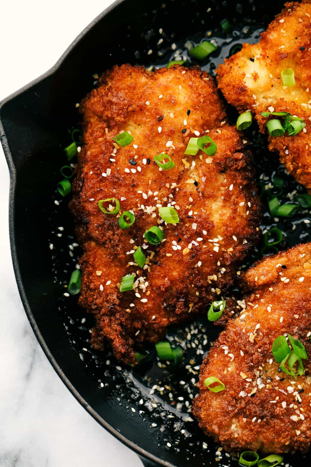 Awesome Chicken Katsu is a crispy breaded chicken breast seasoned and dipped inย Panko then lightly fried in oil until the crust becomes a golden brown. A light and savoryย Japaneseย dish!ย Chicken Katsu fired golden brown.