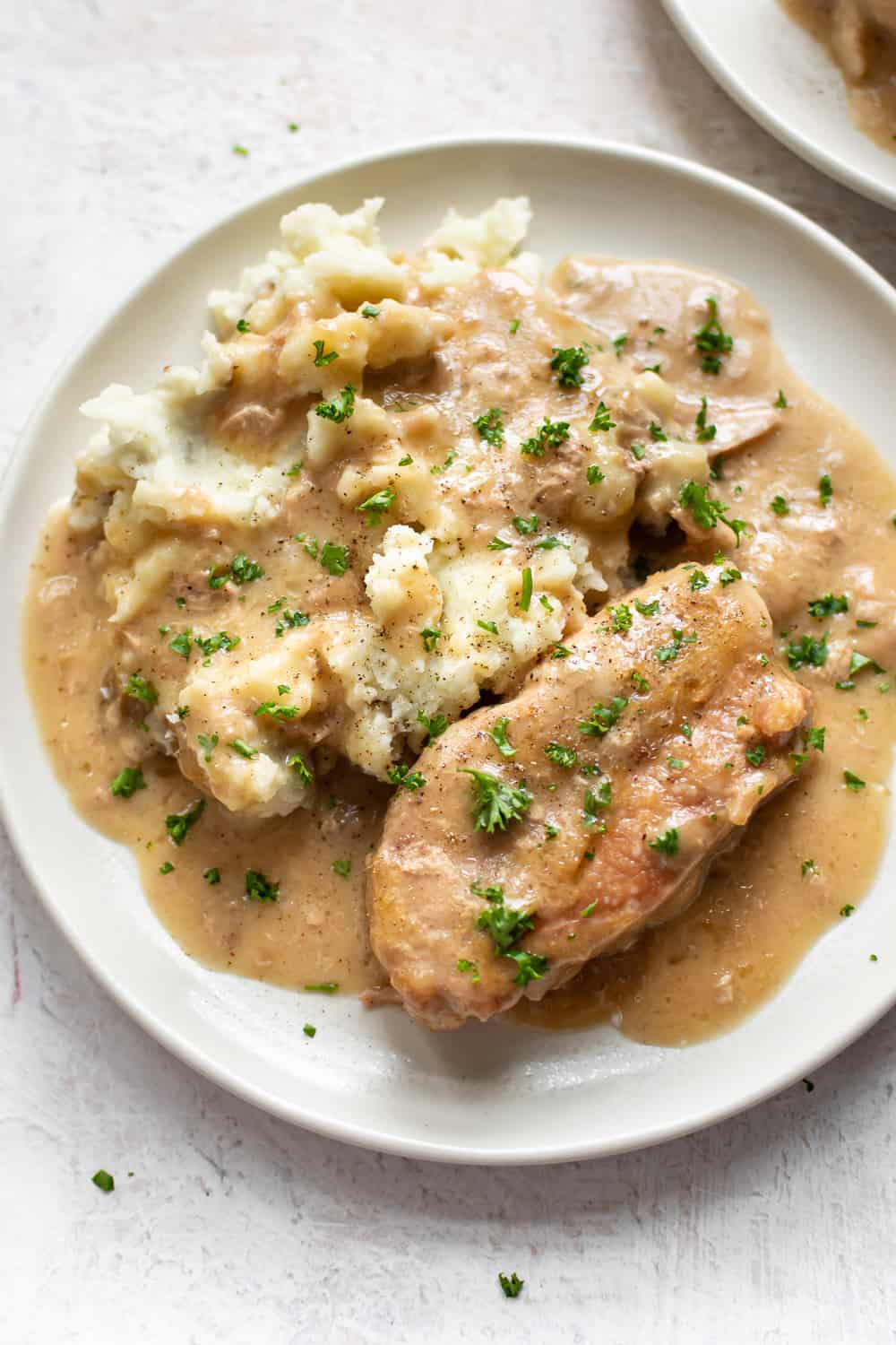 These Crock-Pot Pork Chops are fall-apart tender and ridiculously simple to make. The perfect comforting family meal! Crockpot pork chops with gravy