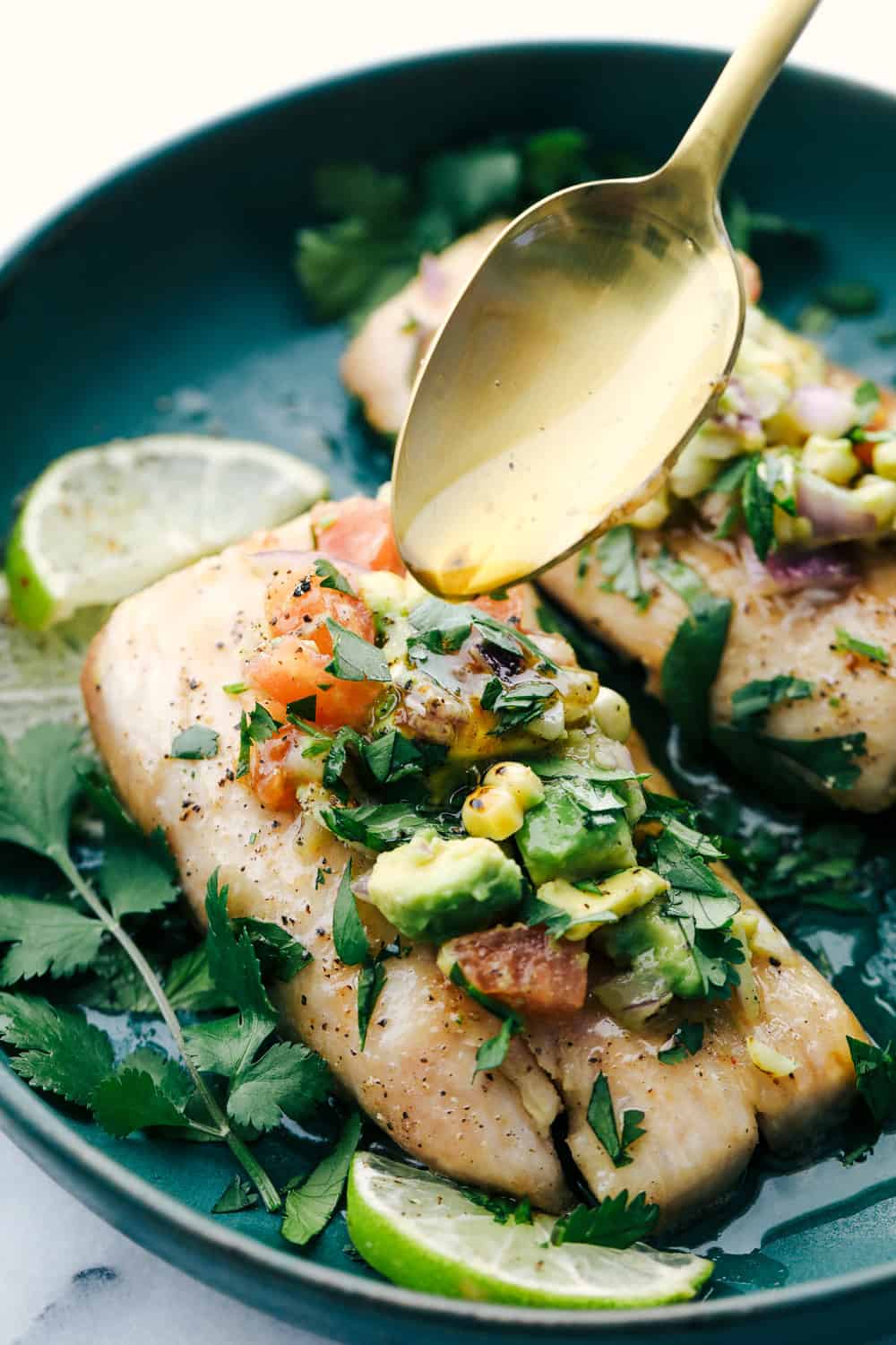 Mahi Mahi is aย tender filet cooked golden brown then in soaked in a brown butter sauce and garnished with a fresh avocado salsa. Anย irresistible Dinner! Mahi Mahi served on a plate garnished with avocado salsa and drizzled with brown butter sauce.