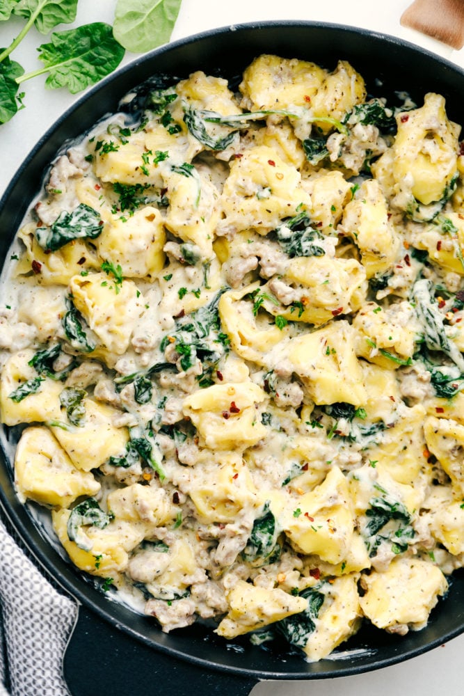 This sausage tortellini skillet is perfect for a creamy and savory dinner that is simple and tastes amazing with all the flavors blended together. It is a family favorite!ย Sausage tortellini skillet in cooked together in a skillet.