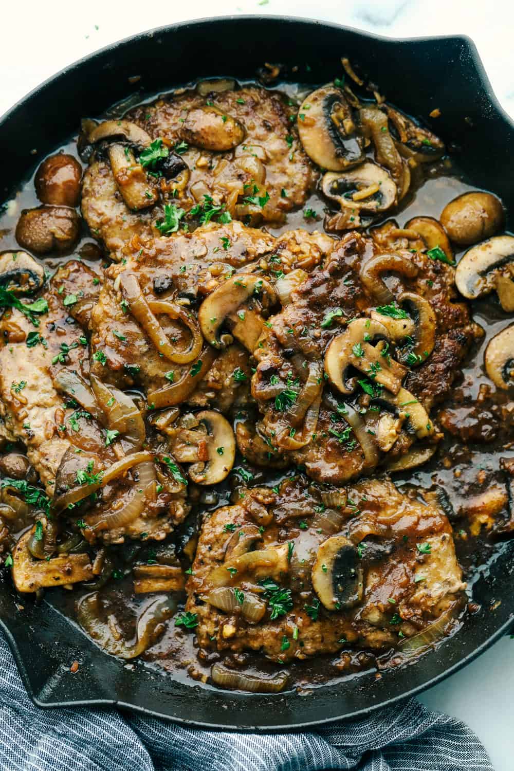 Cube steaks are my go-to budget comfort food. They're quick, cozy, and smothered in gravy. I love them with mashed potatoes or veggies, and I’ve got a simple trick to keep them melt-in-your-mouth tender every time. Cube steak cooked in a mushroom gravy sitting in a skillet.