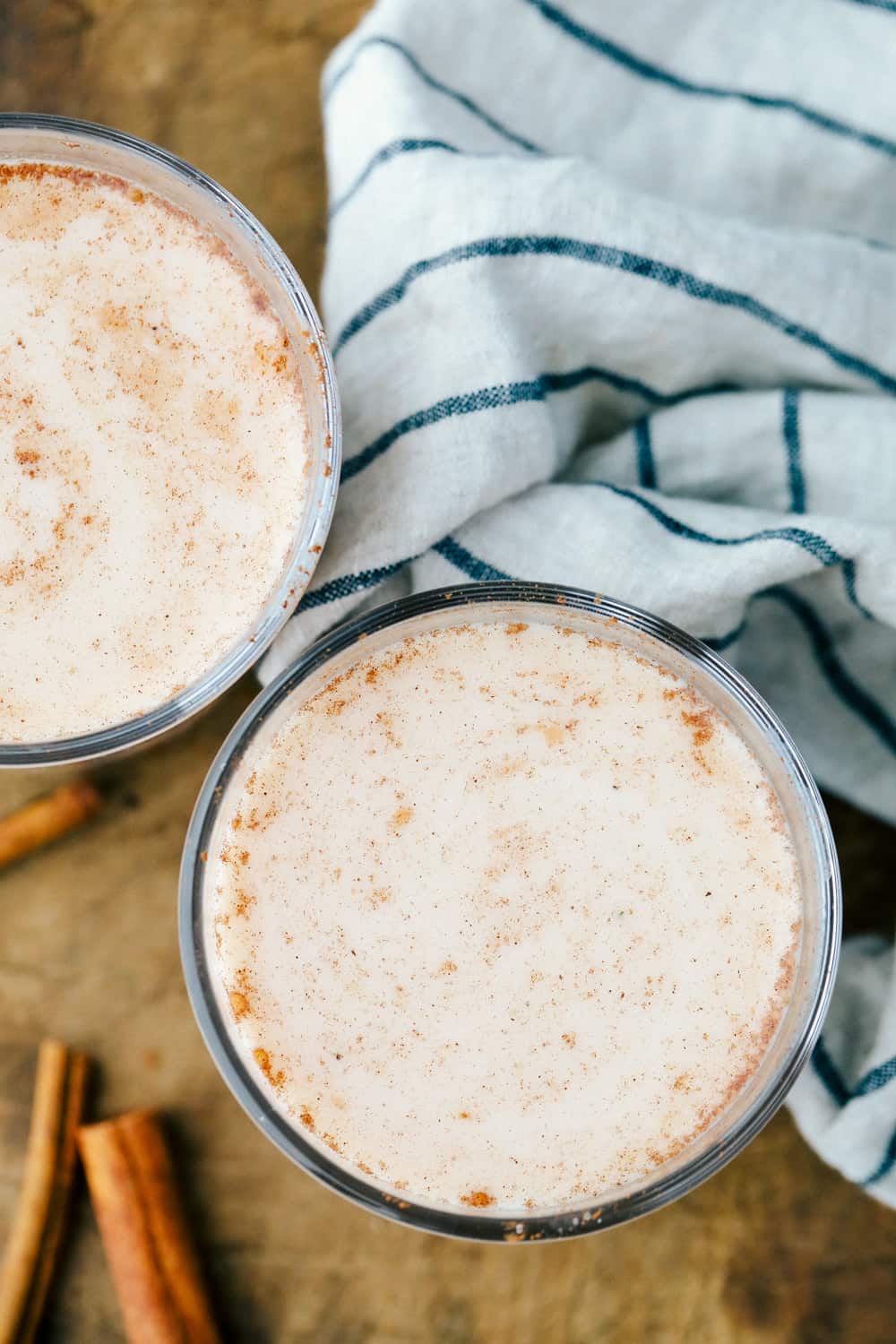 Best Ever Horchata is a smooth andย creamy cold drink that blends rice soaked in water and sweetened with cinnamon making this authentic Mexican drink rich and milky. Aย delicious sweet cinnamon flavored Mexican drink!ย A photo of the top of the glass cup with horchata in it sprinkled cinnamon.