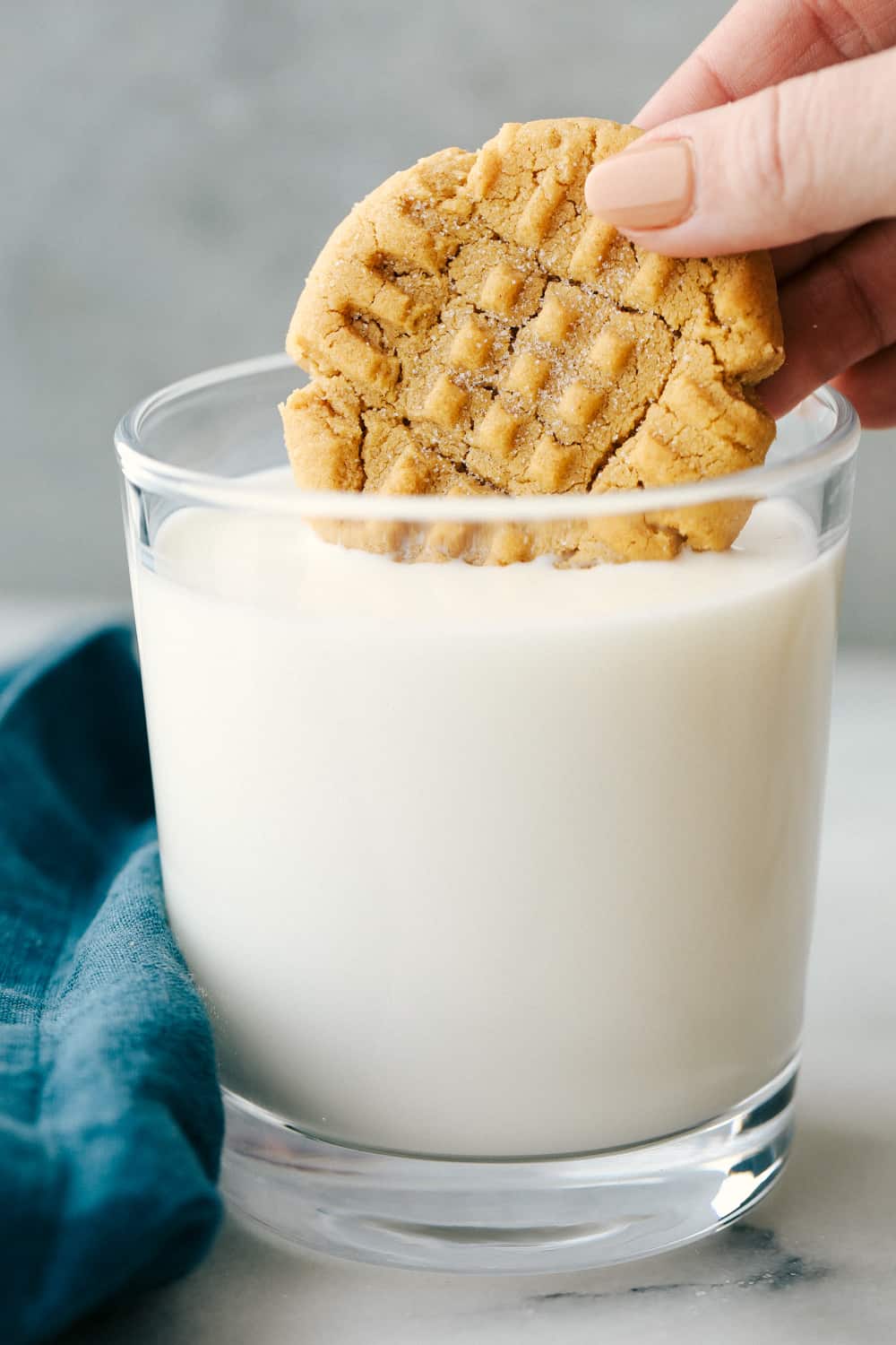 Easy 3 Ingredient Peanut Butter Cookies are soft, fluffy and full ofย creamy peanut butter with sweet sugar and a large egg, it is that simple. Only 3 Ingredients to make theseย deliciously desirable cookies!ย 3 Ingredient peanut butter cookie dipped in a cold glass of milk.