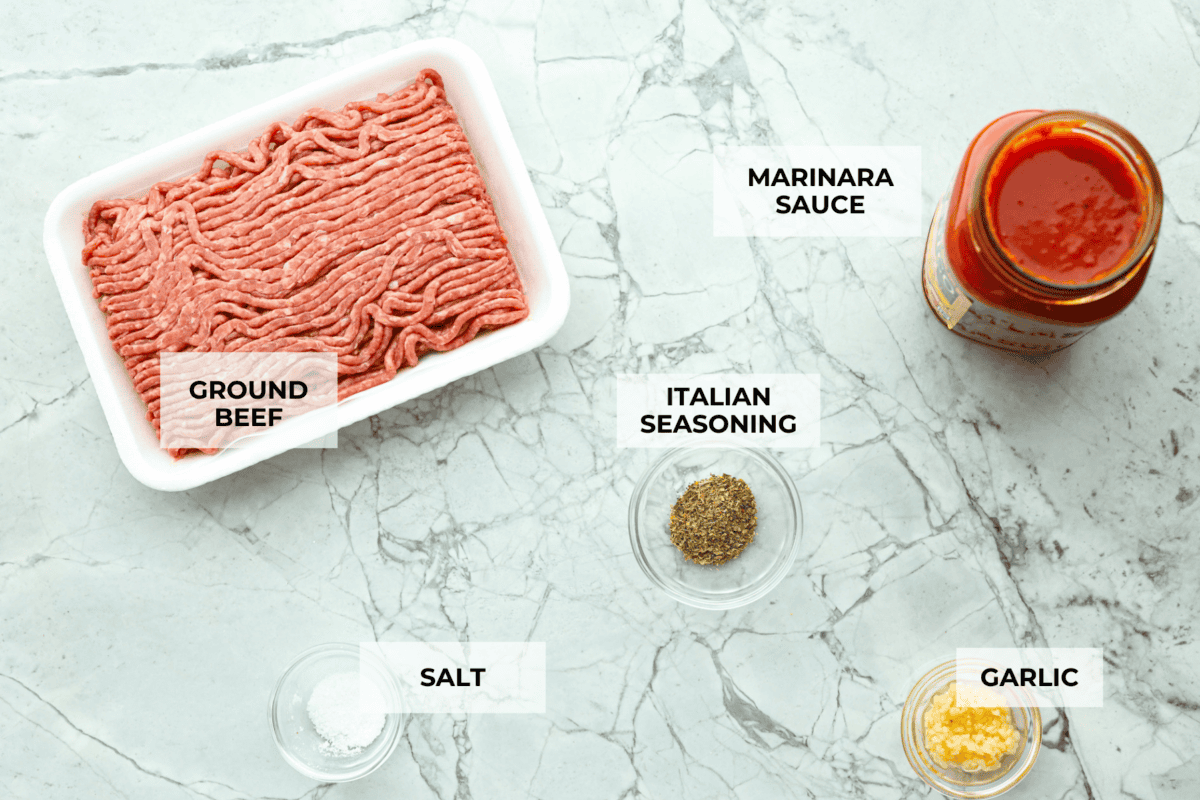 These Lasagna roll-ups have all the flavors of a classic lasagna wrapped up in a fun lasagna twist! This recipe is an easier approach to this classic Italian comfort food; seasoned beef, sweet marinara sauce, and melty, creamy cheese wrapped in a perfectly al dente noodle. Overhead shot of labeled meat sauce ingredients.