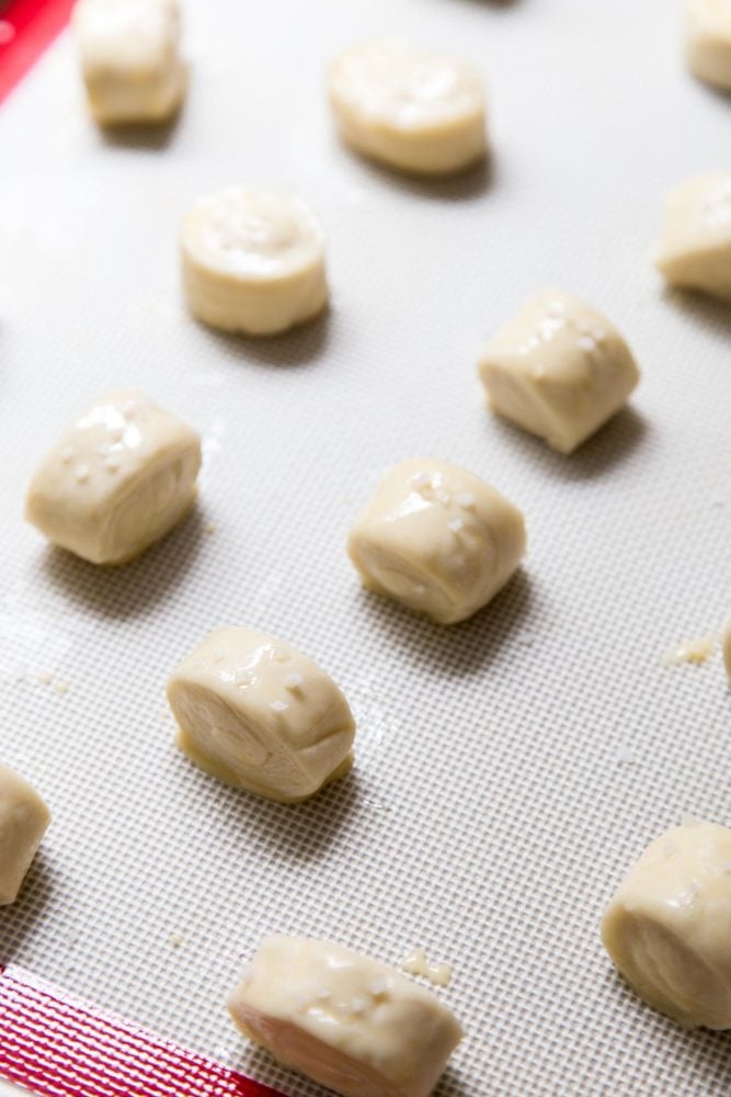 Pretzel Bites are the perfect afterschool snacks, game day appetizers, and popcorn replacement for movie nights. The outside of each pretzel bites is golden brown and chewy, while the inside is soft and fluffy. Unbaked pretzel bites on a baking tray