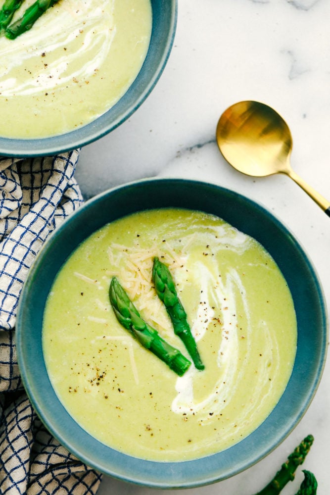 This asparagus soup is rich, flavorful and creamy not to mention it is simple to make! The velvety texture melts in your mouth leaving you wanting more. Asparagus soup garnished with asparagus tips.