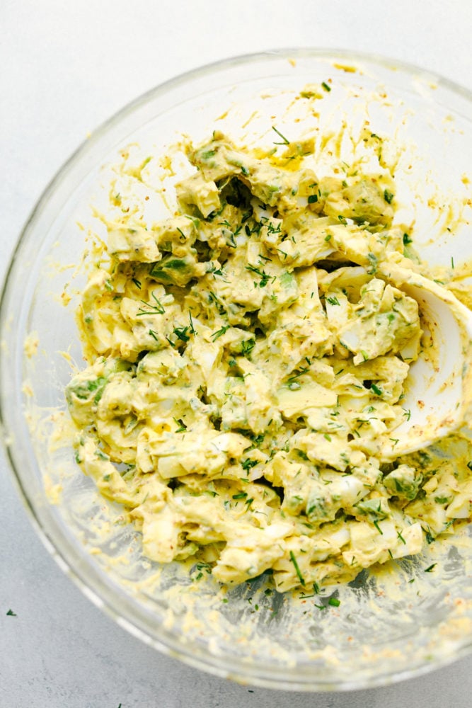 Avocado egg salad is a twist on egg salad adding in the avocado for the color and delicious flavor! Add this to any sandwich or eat it straight from the bowl, it will be a new favorite! Avocado egg salad mixed together.