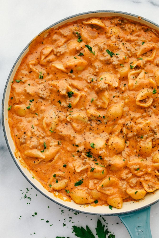 This cheesy beef and shells recipe is so simple to make with just a few ingredients straight out of your pantry, plus it all comes together in 20 minutes. Comforting, cheesy dinner that the whole family will love! Cheesy beef and shells in a skillet cooked together.