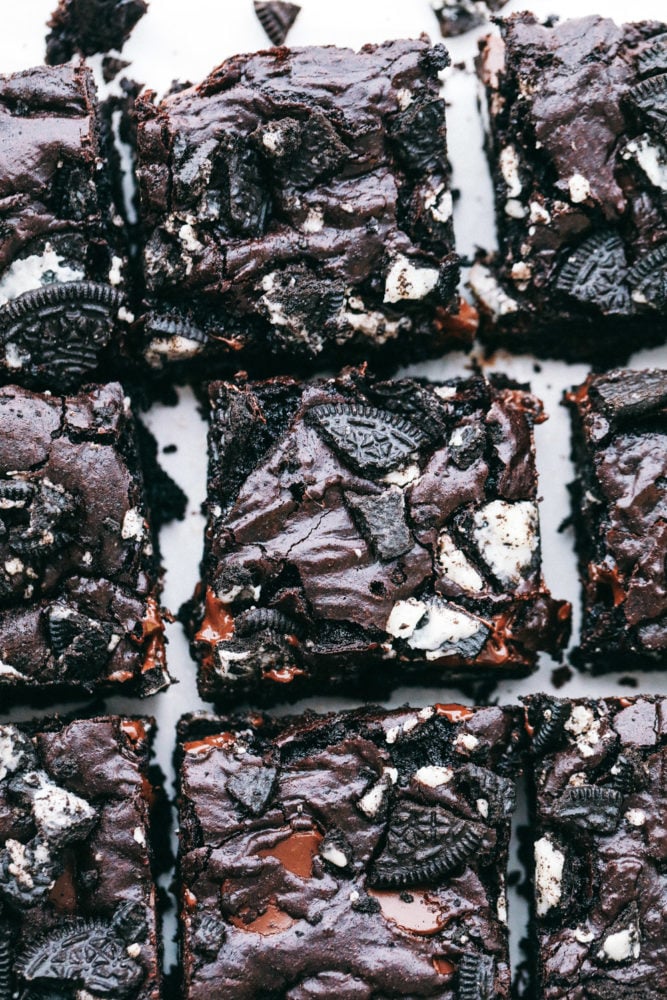 These brownies are layered with a rich chocolatey batter with Oreos in the middle creating a soft, gooey center with chunks of chocolate and Oreo pieces in every bite. Oreo brownies make everyday a great day! Oreo brownies photo over head of cut up brownie slices.