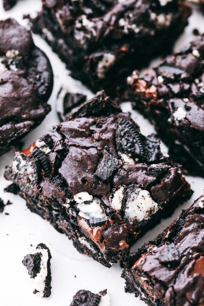 These brownies are layered with a rich chocolatey batter with Oreos in the middle creating a soft, gooey center with chunks of chocolate and Oreo pieces in every bite. Oreo brownies make everyday a great day! Oreo brownies cut into servings.