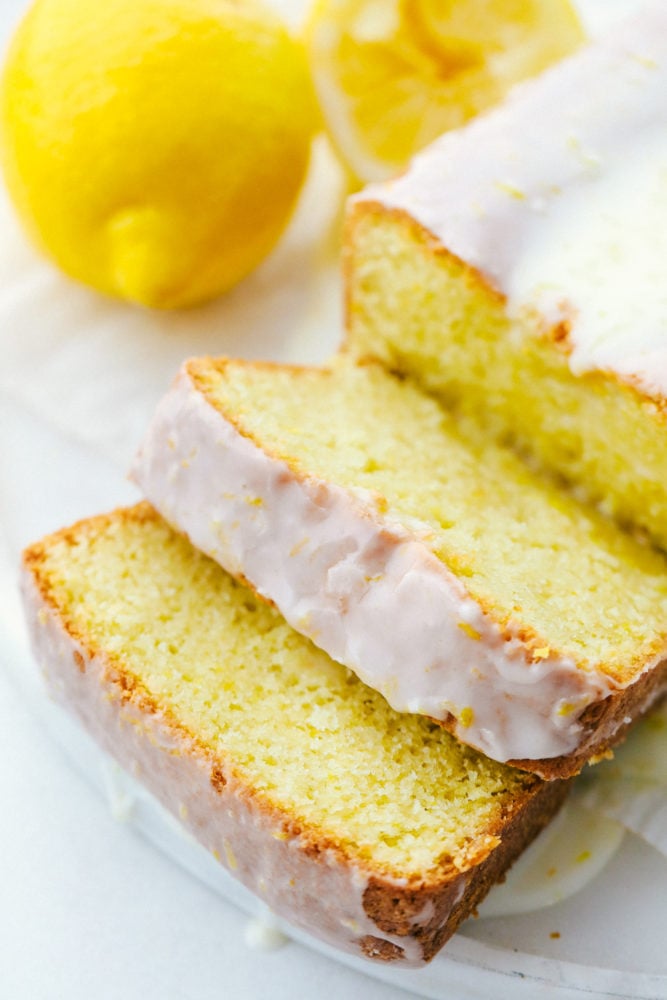 Glazed Lemon Bread is a soft, moist bread bursting with citrus lemon flavor and topped with a shell of sweet lemon glaze. This quick and easy homemade bread is great for sharing or savoring!! Slices of glazed lemon bread.
