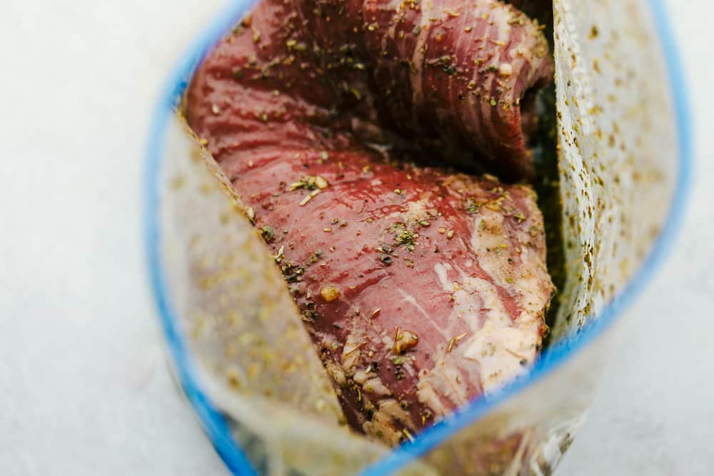 This perfectly grilled flank steak is tender and juicy and topped with the most delicious chimichurri sauce. Combined this main dish is one of our family favorites! Ziplock bag with flank steak and marinate.