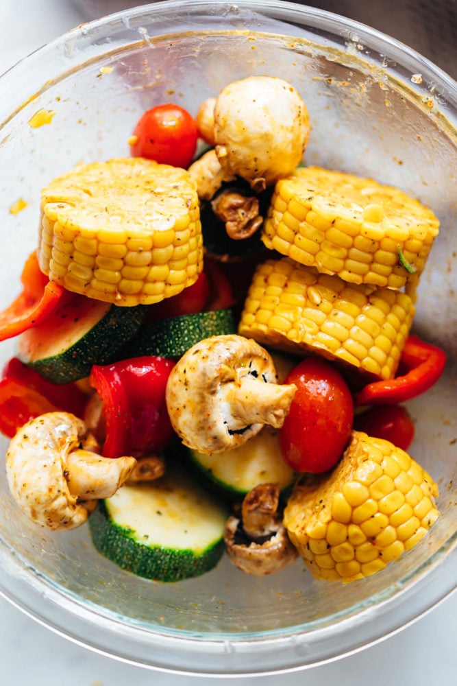 Grilled Vegetable Kabobs are tossed in a spicy lemony marinade and grilled till lightly charred. They soak up all the flavour and become juicy, tender but remain slightly crunchy. Marinated grilled vegetable kabobs in a bowl