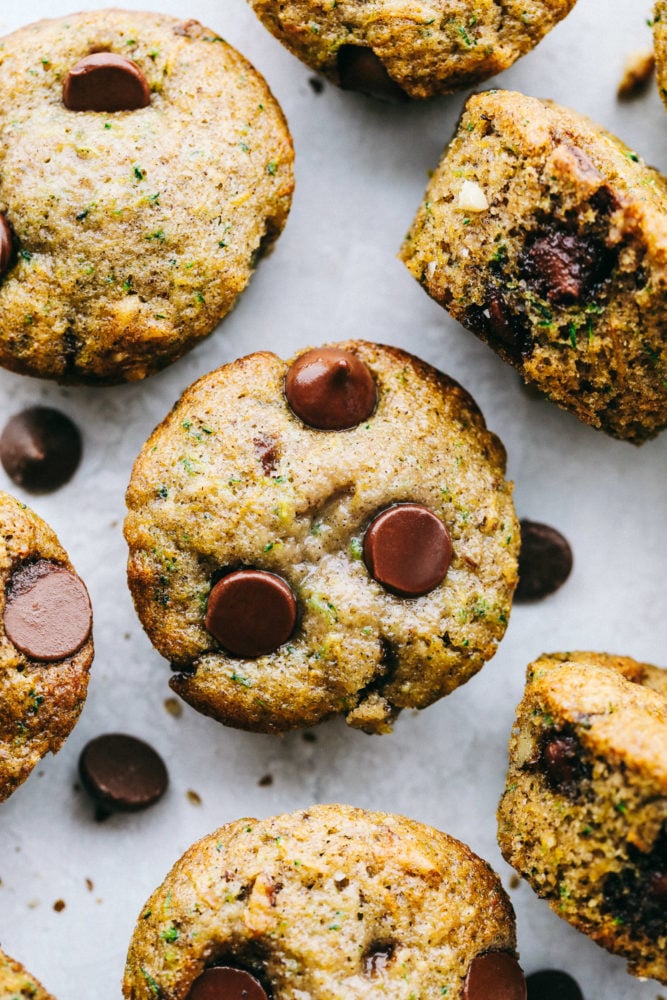 Chocolate Chip Zucchini Muffins are moist and rich muffins that are loaded with flavor from rich chocolate and shredded zucchini!ย They will be a huge hit and will give you a great way to use all that zucchini from your garden! Areal view of chocolate chip zucchini muffins.
