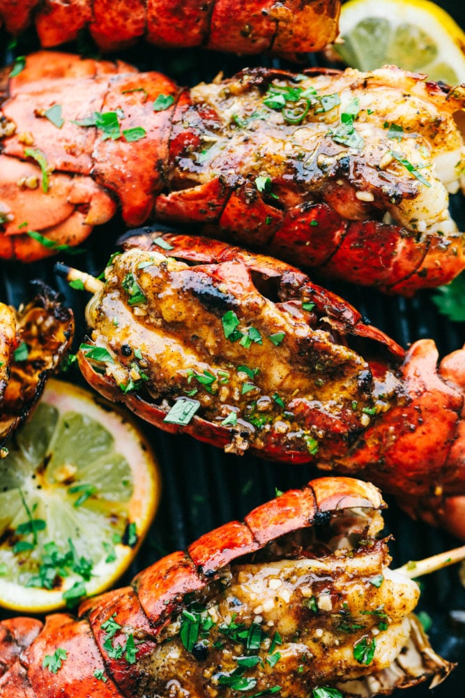 Grilled Cajun Garlic Butter Lobster Tails are buttery and savory and they make a normal night at home seem so fancy! To elevate your next dinner party be sure to include these in your plans! Close up on lobster tail.