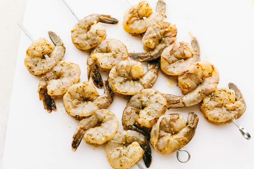 The BEST Grilled Shrimp is the perfect weeknight meal because it is super quick, full of flavor, and so easy to make!ย Everyone will absolutely love and devour it!! Grilled shrimp ready to grill on a skewer.