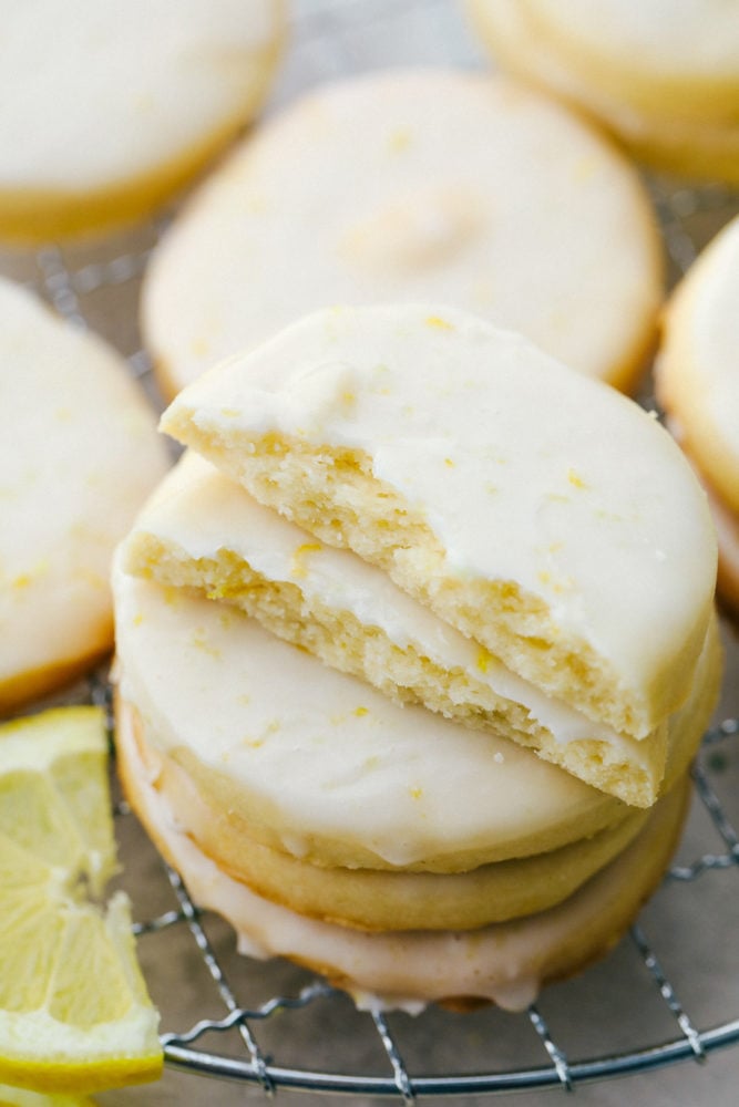 Buttery Lemon Shortbread Cookies with a Glaze are light and fresh with vibrant sweet and sour flavors that are surprisingly easy to create! Every bite is packed with a burst of lemon flavor and the shortbread has the perfect dense, buttery texture that will make this your new favorite cookie! Close up on a stack of lemon shortbread cookies.
