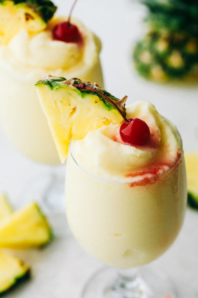 This Pina Colada is a sweet, creamy, frozen drink bursting with fruity flavors from pineapple and coconut. The flavors are so vibrant, they will transport you from your porch to a lounge chair at a tropical beach! Areal view of a finished pina colada.