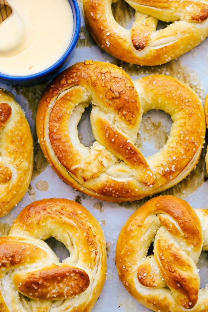 Baked Soft Pretzels are soft and chewy on the inside with the perfect salty golden exterior.ย This recipe will walk you through these easy homemade pretzels with step by step instructions! Close up on finished pretzels.