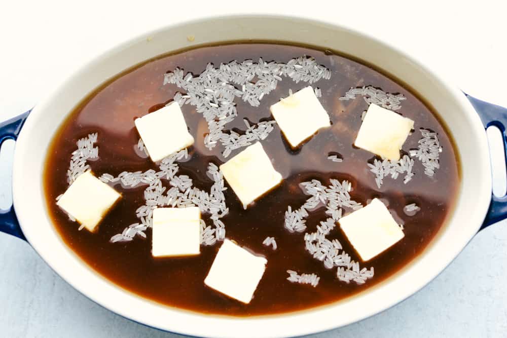 Stick of Butter Baked Rice is soft and fluffy rice that is loaded with sweet, rich flavors from onion soup and butter.ย It is quick and easy to prep and bakes in the oven to perfection! Stick of butter rice prepped and ready to be put in the oven.