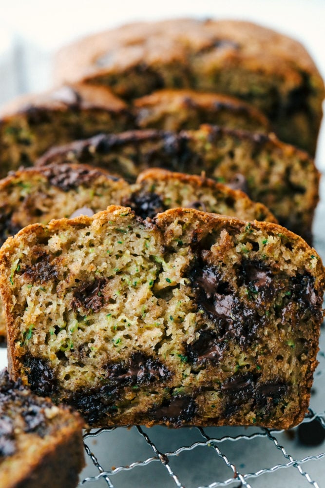 Perfect Chocolate Chip Zucchini Bread is soft and sweet and incredibly easy to make from scratch at home.ย It's the best zucchini bread and tastes amazing with coffee for a satisfying breakfast or as delicious afternoon snack! Sliced chocolate chip zucchini bread.