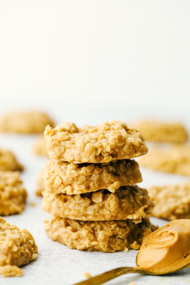 Peanut Butter No Bake Cookies are an easy to make family favorite dessert.ย They are loaded with peanut butter flavor and an addictive chewy texture you won't be able to get enough of!ย Stack of peanut butter no bake cookies.