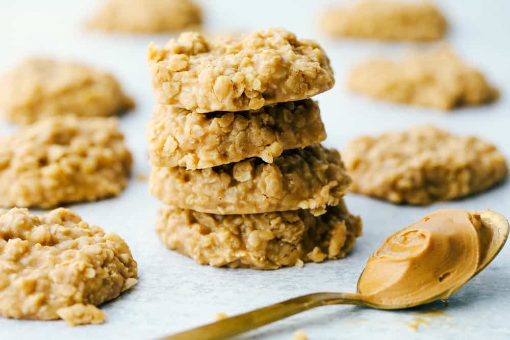 Peanut Butter No Bake Cookies are an easy to make family favorite dessert.ย They are loaded with peanut butter flavor and an addictive chewy texture you won't be able to get enough of!ย No Bake Peanut Butter Cookies in a stack.