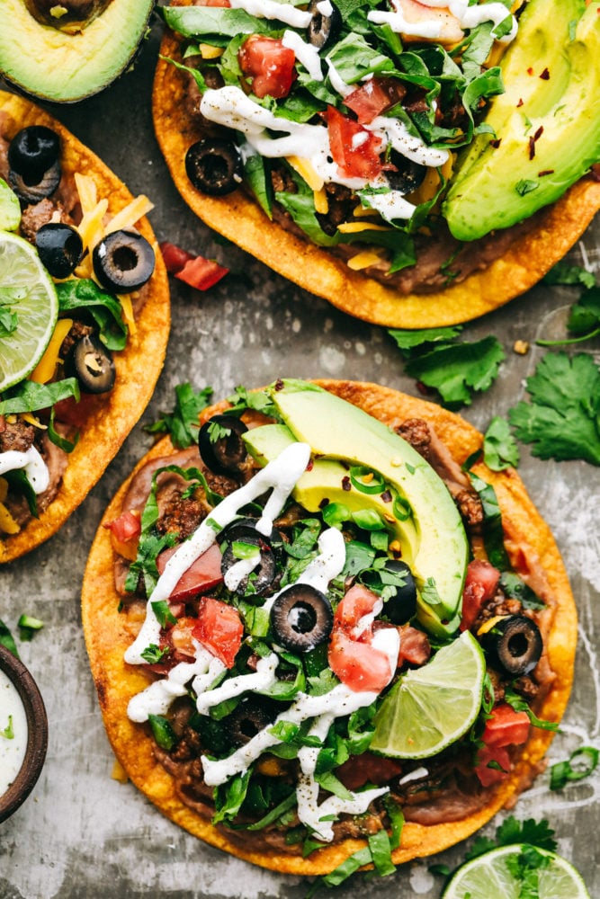 These Tostadas are easy to make and layered with flavorful toppings that make this main dish one of the best! Create a delicious dinner right at home within minutes! Three tostadas layered with optional toppings.