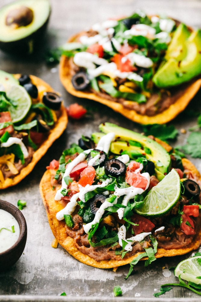 These Tostadas are easy to make and layered with flavorful toppings that make this main dish one of the best! Create a delicious dinner right at home within minutes! Tostadas with layers of optional toppings.