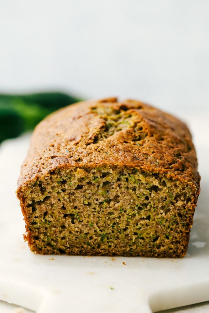You better believe I count down to zucchini season so I know when I can make this delicious Zucchini Bread! It’s moist, perfectly spiced, and loaded with the best flavor and a hint of veggies! Zucchini bread facing out with the bread sliced.