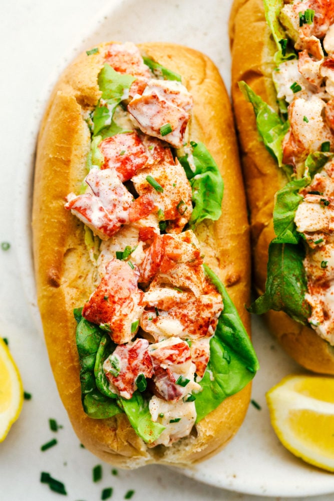 An Easy Lobster Roll is a heavenly sandwich with a soft and chewy bun that's stuffed with cool, fresh lobster salad made from a sweet mayonnaise base. Every bite is packed with crave-worthy flavor that is light and tasty! Close up on finished lobster roll.